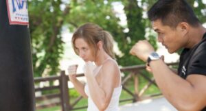 man and woman doing boxing training
